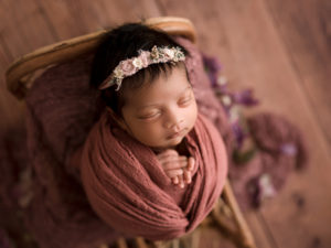 Newborn Baby Photographer, sleeping newborn baby girl with pink blanket and floral headband